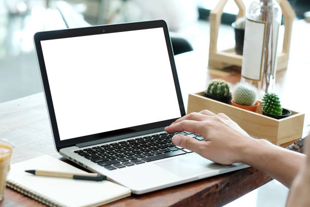 istock Man hands typing laptop computer with blank screen for mock up while sitting in the cafe, technology and lifestyle concept 874836386