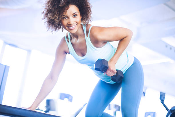 istock Young Woman Weightraining at the Gym 874837048
