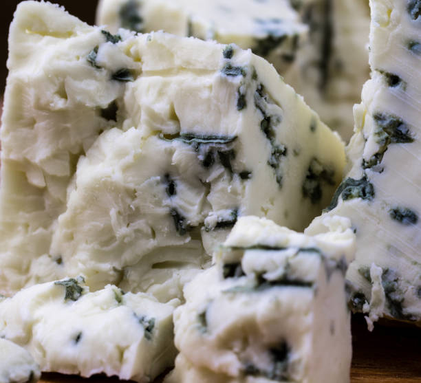 istock Danish blue cheese close up macro with moldy blue veins. 874837474