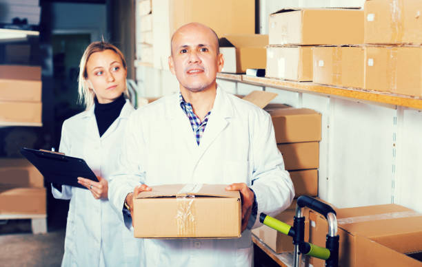 istock Couple transporting cart cardboard cases 874840618