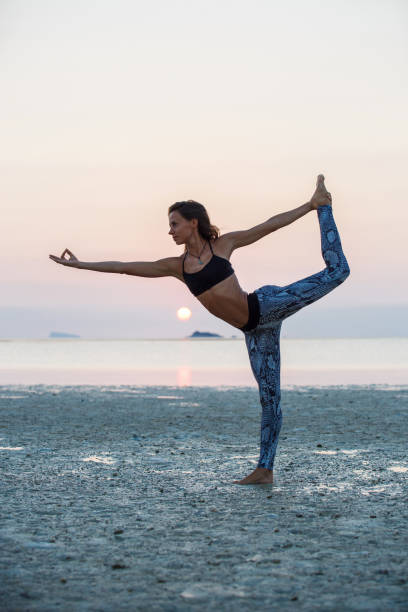 istock Beautiful girl practicing yoga 874844190