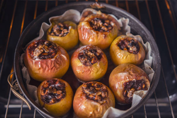 postre saludable, manzana con nueces y mermelada al horno en el horno - baked apple food meal dessert fotografías e imágenes de stock