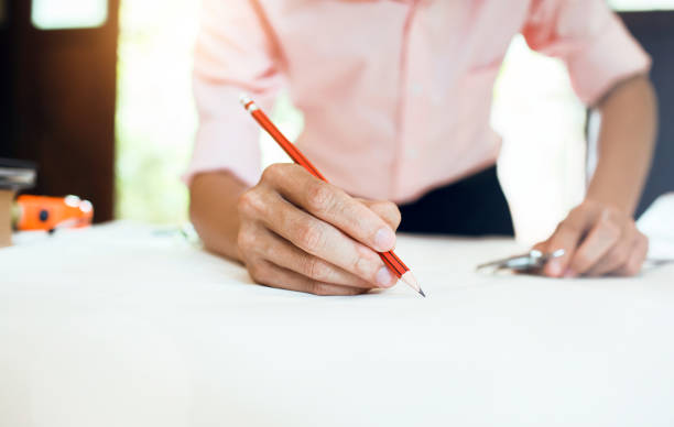 istock Business engineer working hard at his desk in apartment home building concept at construction site main office. 874847204