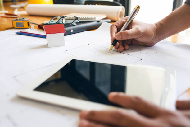 istock Engineer business man hardworking to drawing architect blueprint startup small business for new workplace of his customer for good and strong building design. 874847516