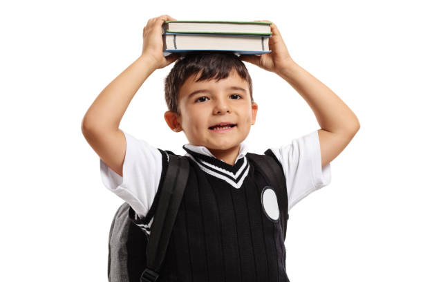 istock Little schoolboy holding books on his head 874848714