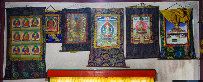 Rumtek, India - November 18, 2011: Buddhist thangkas - a Tibetan Buddhist paintings on cotton, or silk appliques - in a Rumtek monastery, Sikkim, India
