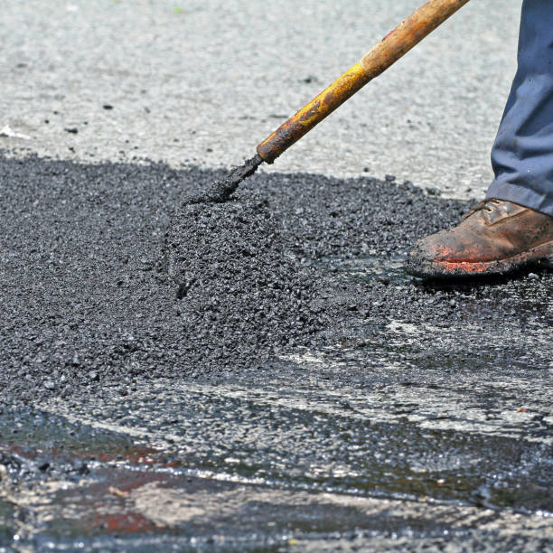 istock Raking Hot Asphalt On Road Repair Site 874851480