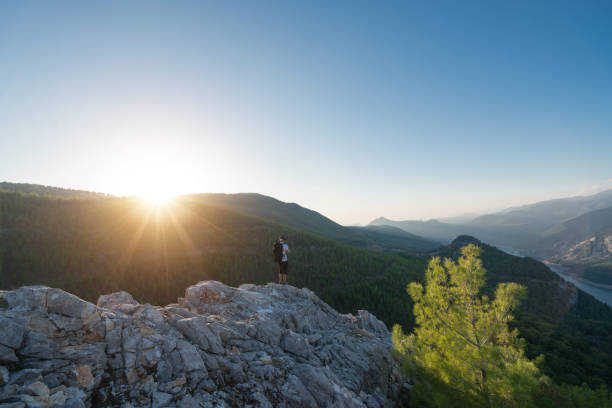 istock Hiker Drone pilot using fpv goggles to fly  in the mountain 874851570