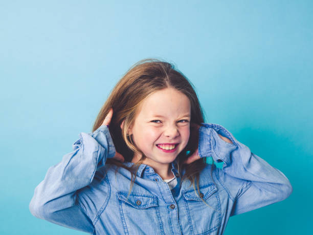 istock young girl in front of blue background 874851736