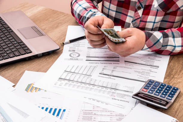 istock man counts money for office work and computer calculation of the budget 874852034