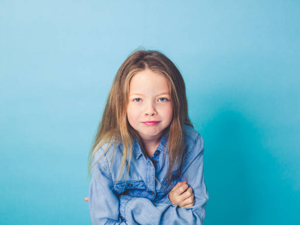 istock young girl in front of blue background 874852482