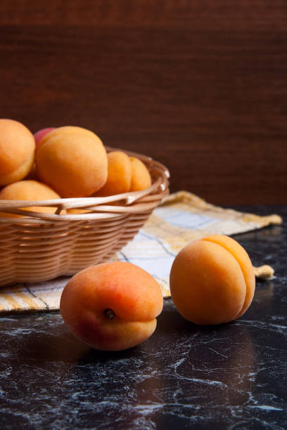 istock Group of harvested apricots in basket. 874856746