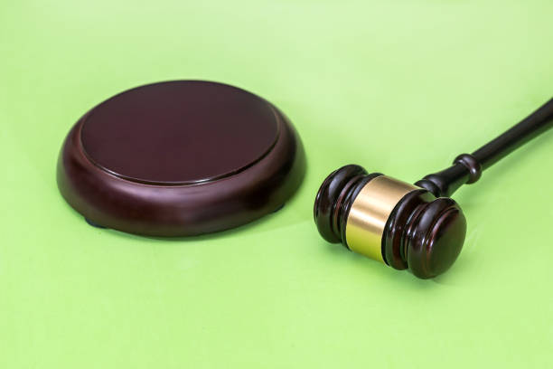 istock Law symbols  -  gavel isolated on green background 874859450