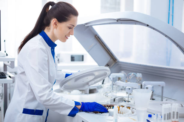 istock Gentle brunette  laboratorian starting centrifuge machine 874859992