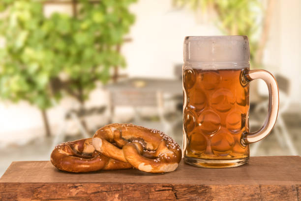 Beer and pretzel in the beer garden Beer and pretzel in the beer garden oktoberfest food stock pictures, royalty-free photos & images