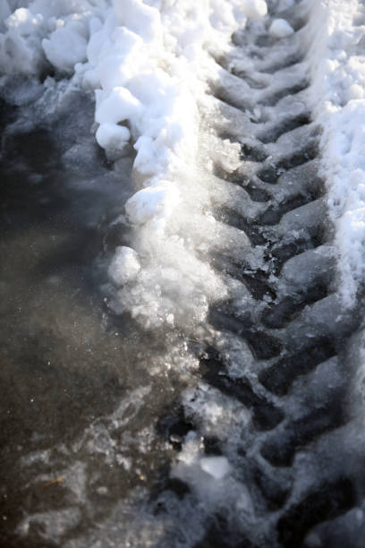 istock Snow traces of car tires 874860286