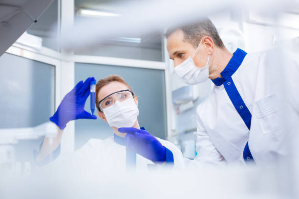 istock Unhappy focused laboratorians talking about test result 874863158