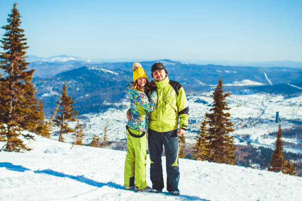 istock couple is standing in the mountains in winter 874863796