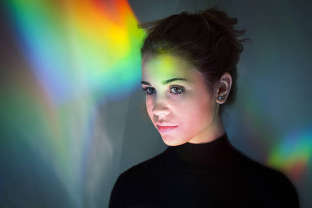 istock Young girl with rainbow reflections 874866886