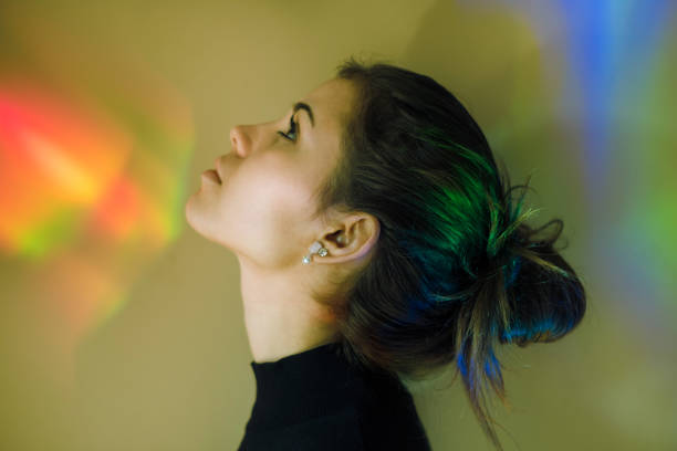 istock Young girl with rainbow reflections 874867022