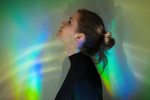 istock Young girl with rainbow reflections 874867826