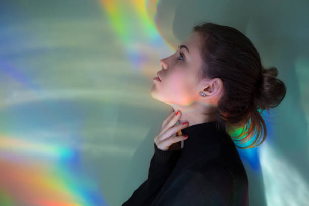 istock Young girl with rainbow reflections 874868080