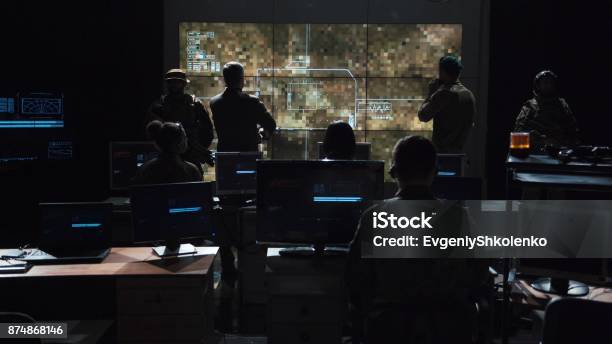 Group Of People In Dark Room Launching A Missle Stock Photo - Download Image Now - Military, Technology, War