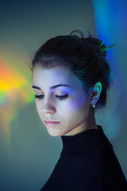 istock Young girl with rainbow reflections 874868234