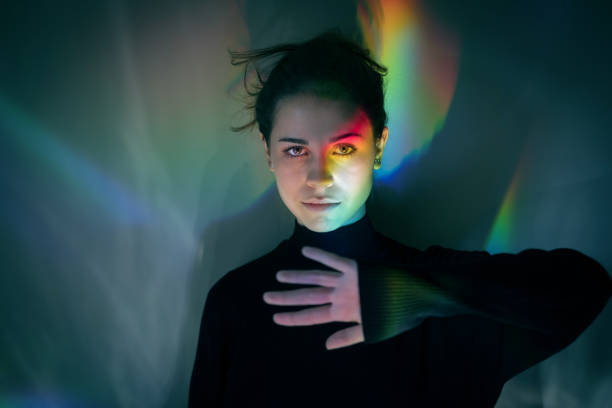 istock Young girl with rainbow reflections 874868294