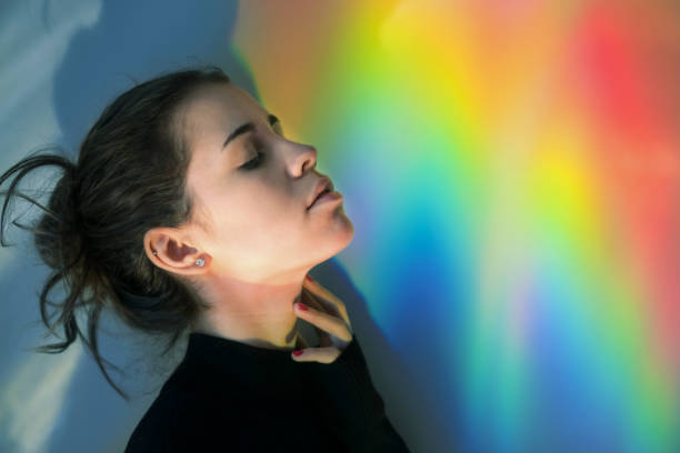 istock Young girl with rainbow reflections 874870620