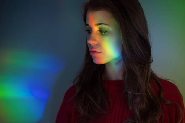 istock Young girl with rainbow reflections 874870790