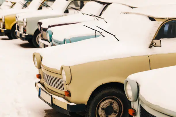 Group of vintage Trabant cars covered in snow in Berlin, Germany