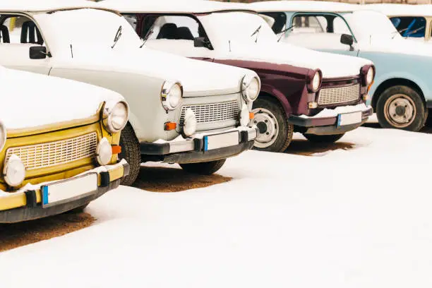 Group of vintage Trabant cars covered in snow in Berlin, Germany
