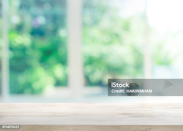 Wood Table Top On Blur Of Window With Garden Flower Stock Photo - Download Image Now