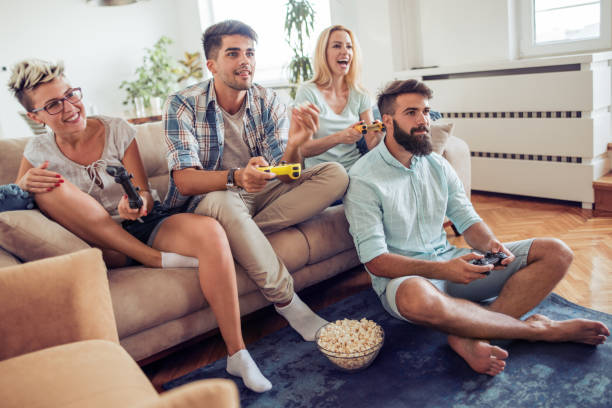 istock Friends having fun-playing video games at home. 874875602
