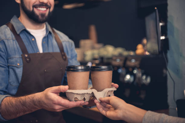 istock Cheerful barista giving mug of beverage 874876006