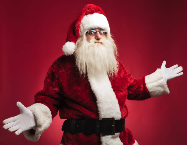 istock happy santa claus welcoming 874876046