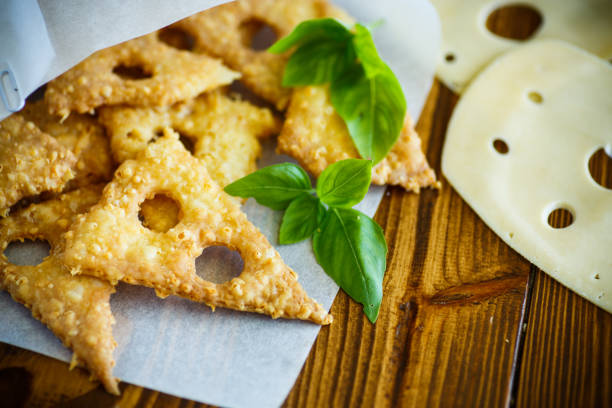 Home cheese crackers in the form of cheese with holes