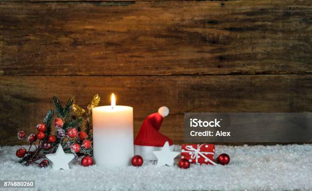 Christmas Decoration With Candle Red Santa Hat And Small Gift Stock Photo - Download Image Now