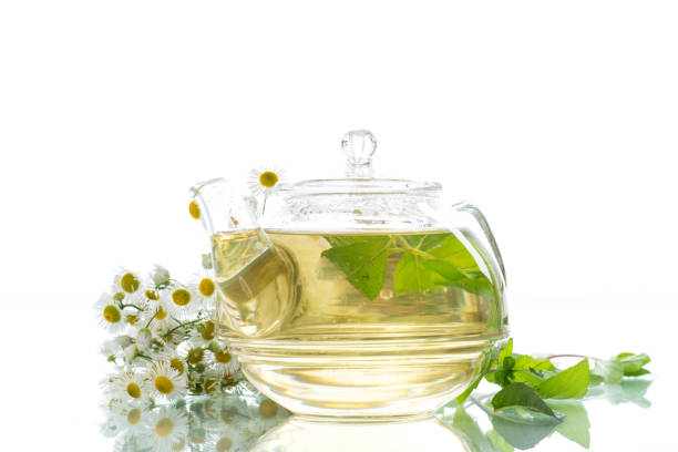 istock Glass teapot with chamomile tea 874880434