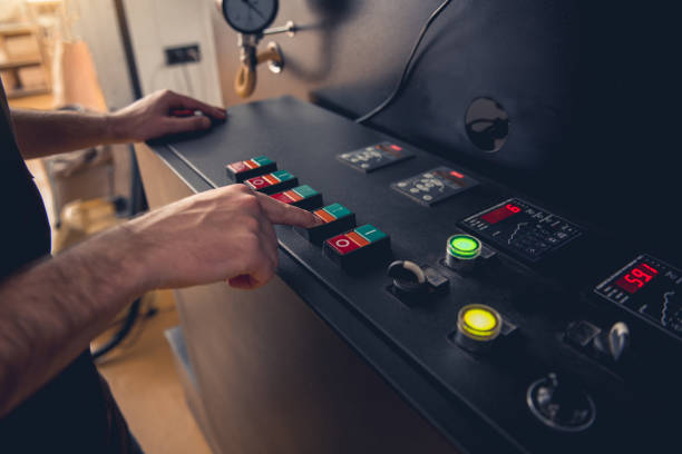 istock Male arms pressing button on special equipment 874887710