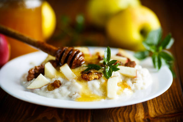 istock sweet milk oatmeal with apples, nuts and honey 874888106