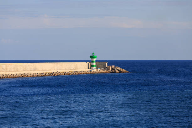 istock Barcelona Seawall and Lighthouse 874888130