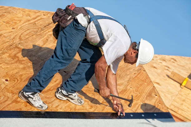 istock Roofer nails down an underlayment on a new roof 874888134