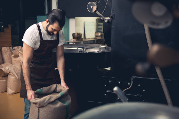 istock Outgoing worker keeping sack full of grains 874888290