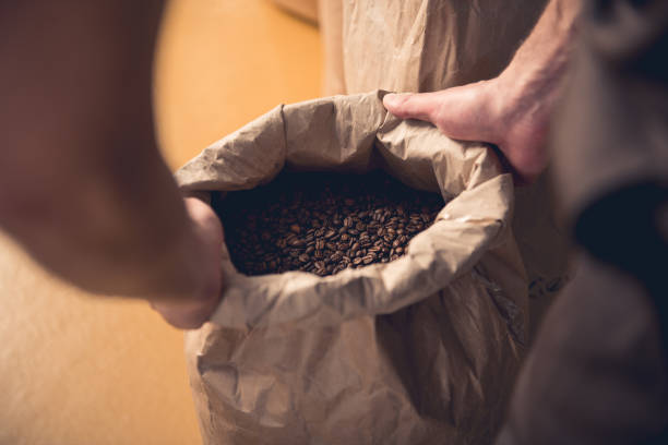 istock Male hands holding bag with coffee beans 874888588