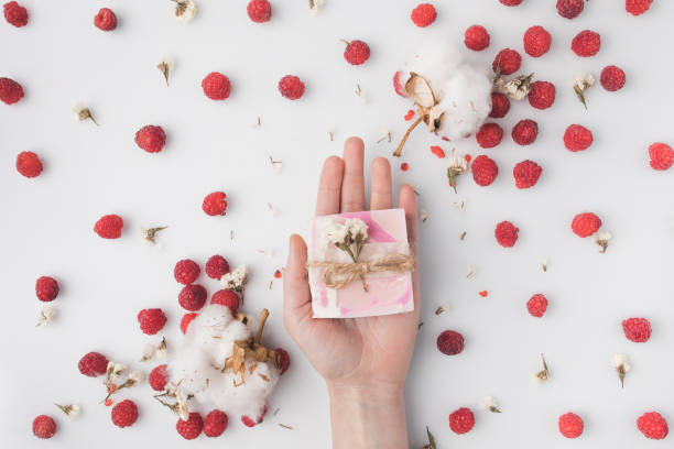 istock woman holding berry soap 874888782