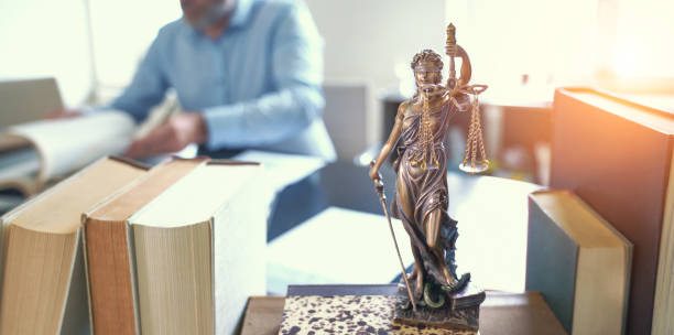 Lady Justice Statue The Statue of Justice - lady justice or Iustitia / Justitia the Roman goddess of Justice standing on books in lawyers office bronze statue stock pictures, royalty-free photos & images