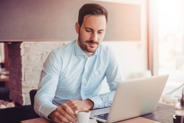 istock Young man working with laptop in office. 874898696