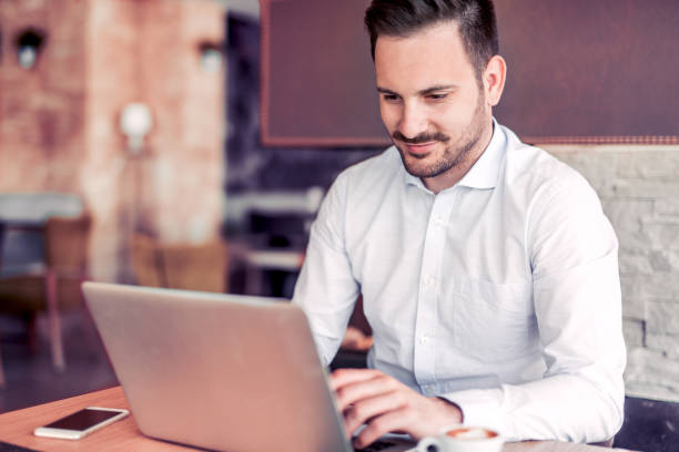 istock Young man working with laptop in office. 874898834